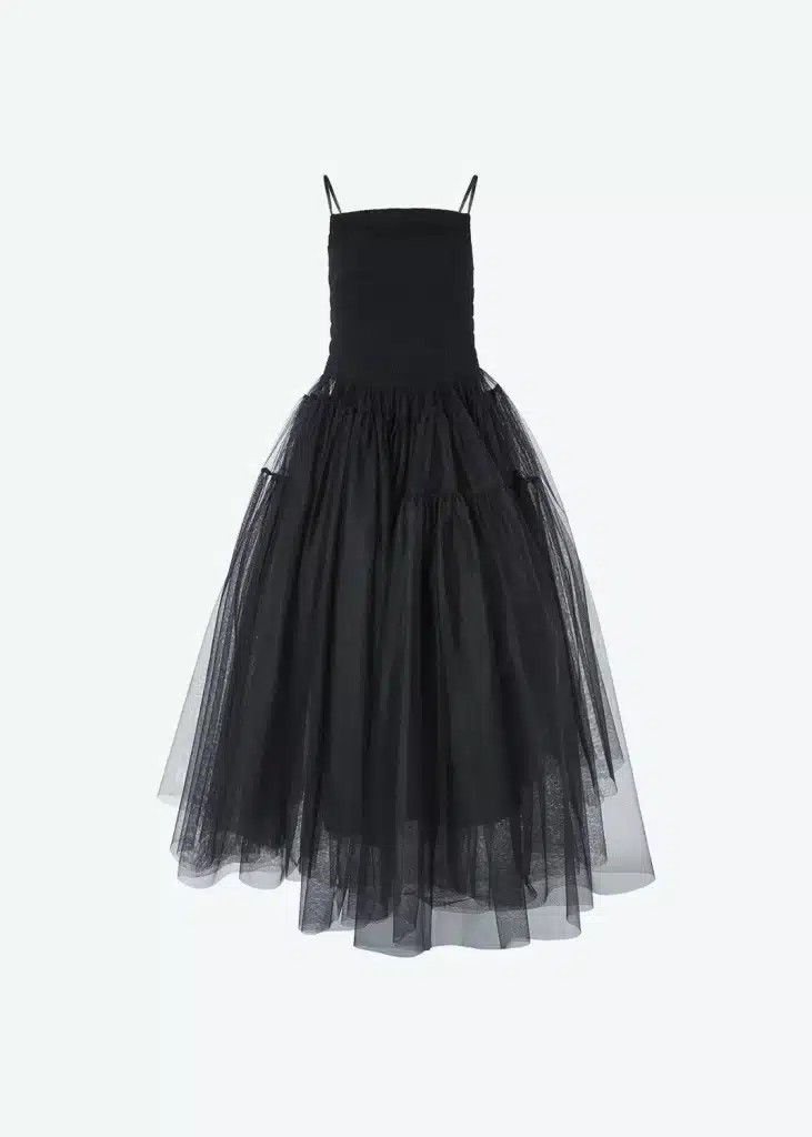 A black tulle dress hanging on a white background.