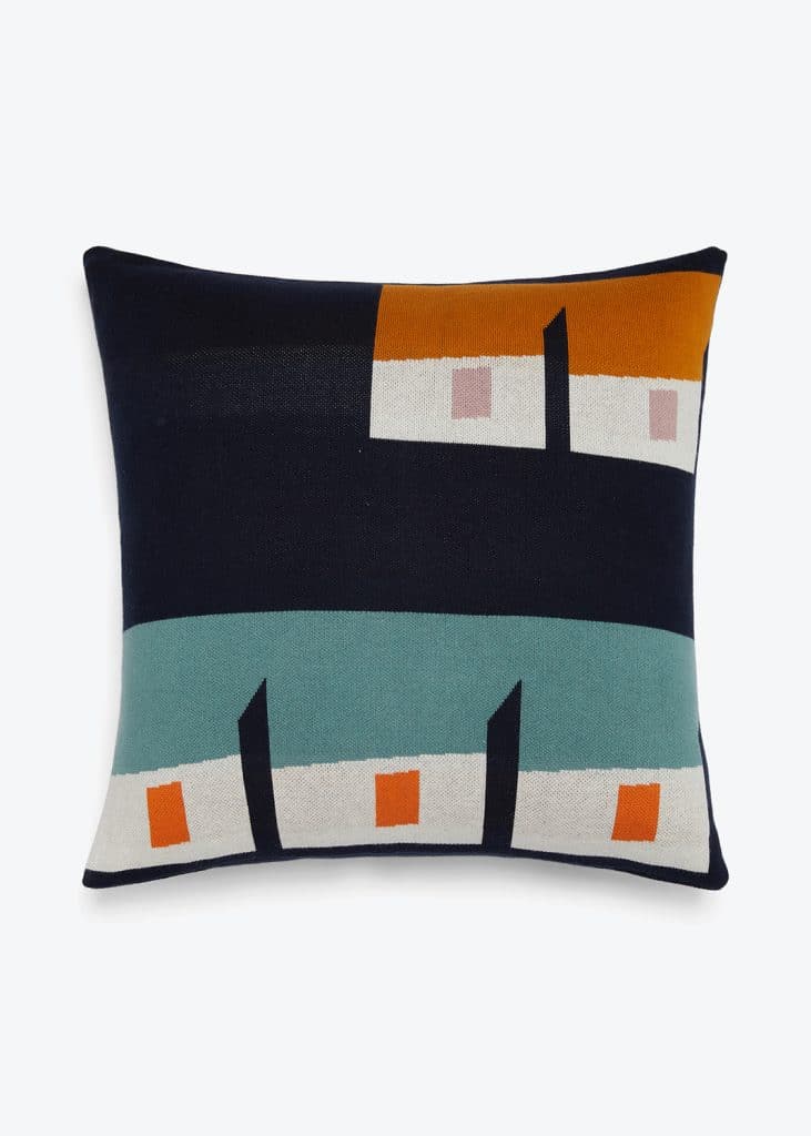 A blue and orange pillow with houses on it from Sophie Home Packshot.